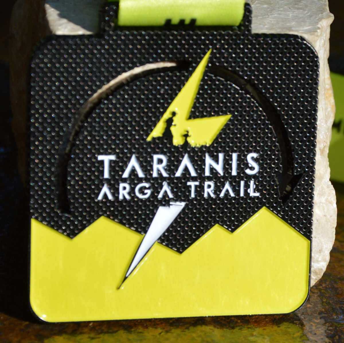 Black and yellow square medal made for the Taranis Arga Trail